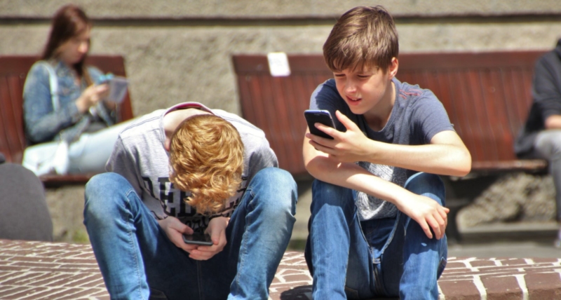 Two young people on their mobile phones