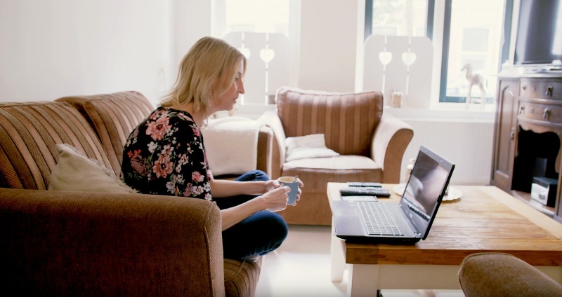 A woman receiving online mental health treatment at home via video calling
